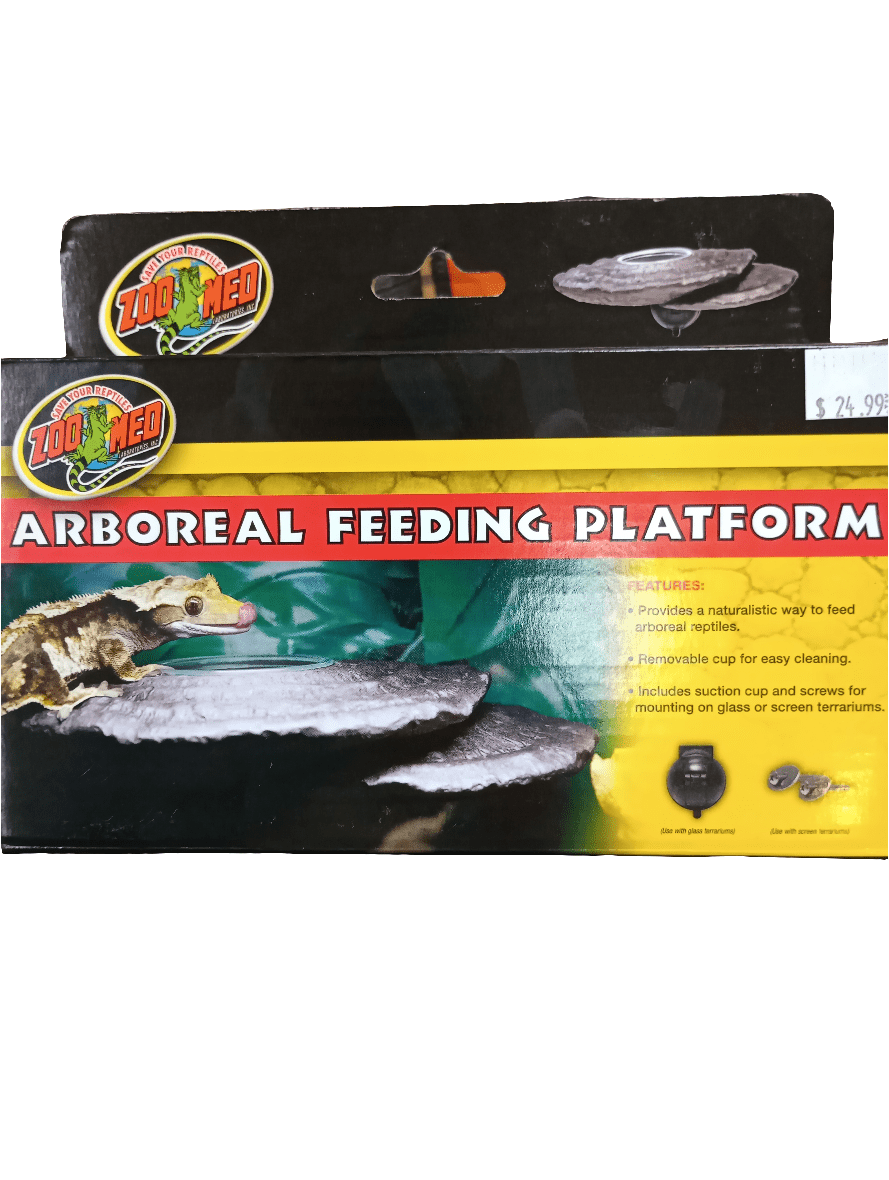 The packaging for the Zoo Med Arboreal Feeding Platform showcases a textured surface adorned with images of a gecko perched on a ledge. On the package, you'll find details about feeding and cleaning. The price tag is clearly displayed in the top right corner.