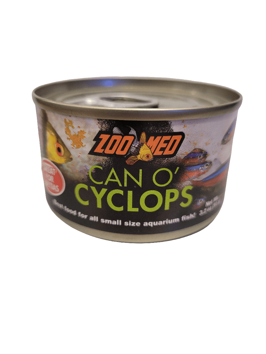 A can labeled Zoo Med - Can O' Cyclops - 3.2oz, featuring images of fish. It is designed as food for small aquarium fish, and the label states: Great for All Small Size Aquarium Fish.