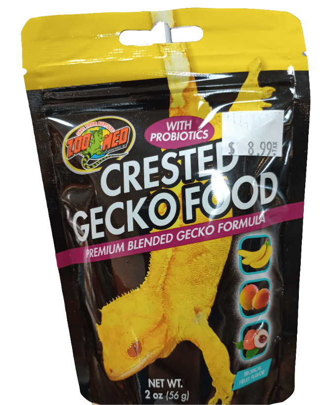 The product, Zoo Med Gecko Food Tropical Flavor, comes in packaging that displays a yellow gecko on the front. The label emphasizes the inclusion of probiotics and a premium blended formula, accompanied by images of assorted fruits. It has a net weight of 2 oz (56 g) and is priced at $8.99.