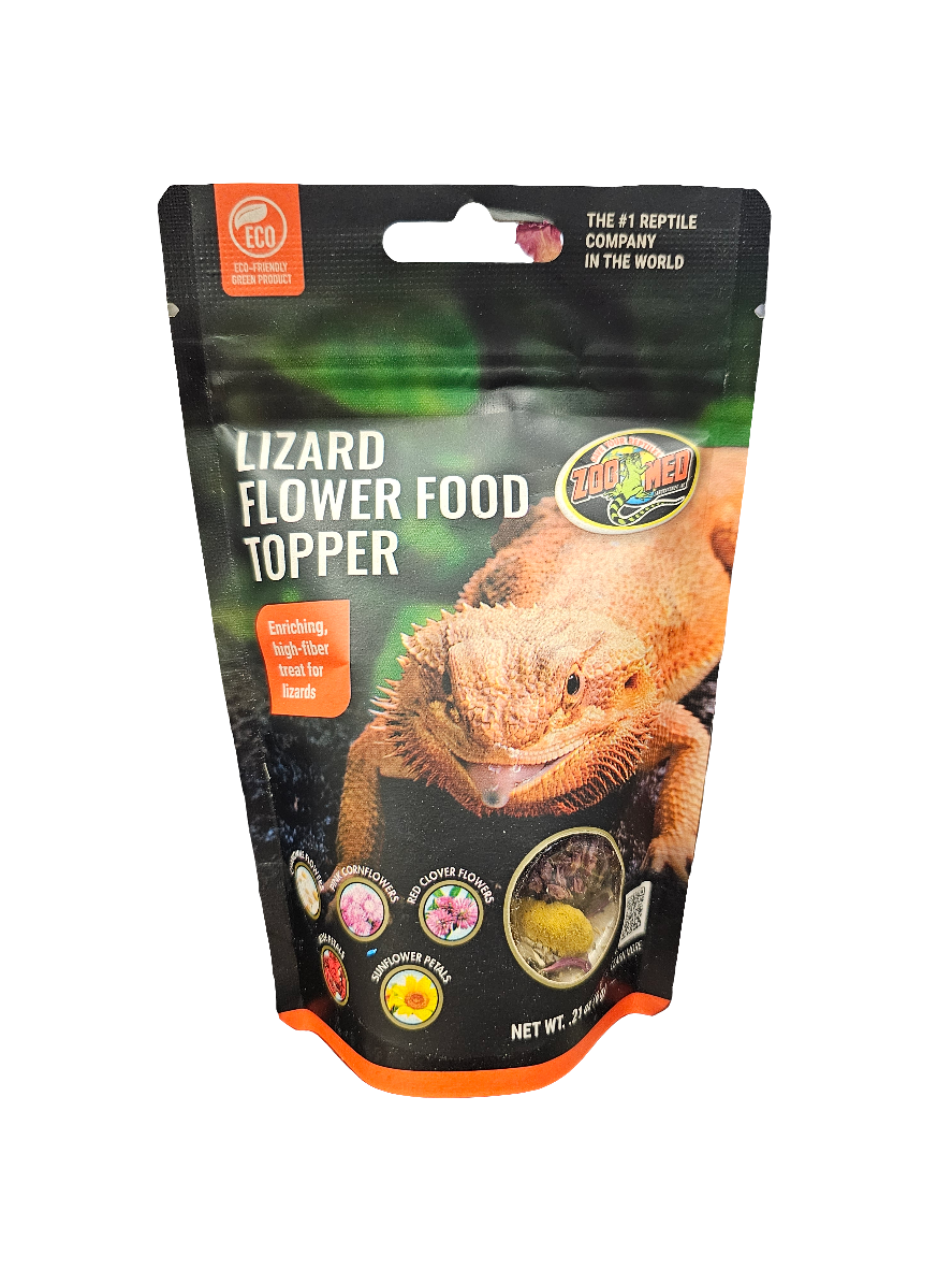 Packaging of Zoo Med - Lizard Flower Food Topper .21 Oz showcases a lizard image and highlights flavors and benefits such as enriching and healthy food for bearded dragons. The black bag features colorful text and illustrations.