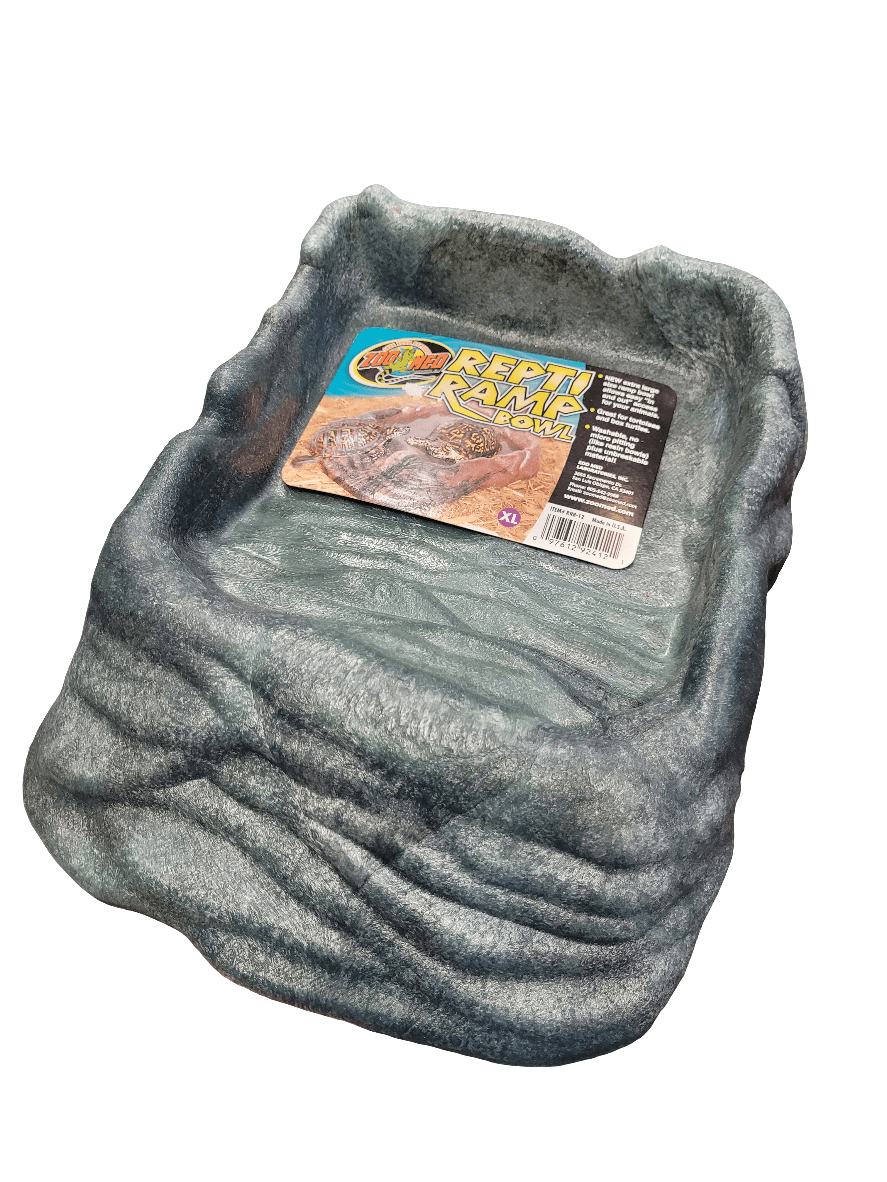 A Zoo Med Repti Ramp Bowl in extra large, featuring a gray, textured rock-like exterior with a smooth interior surface. The inner edge includes a product label with details and a small reptile image.