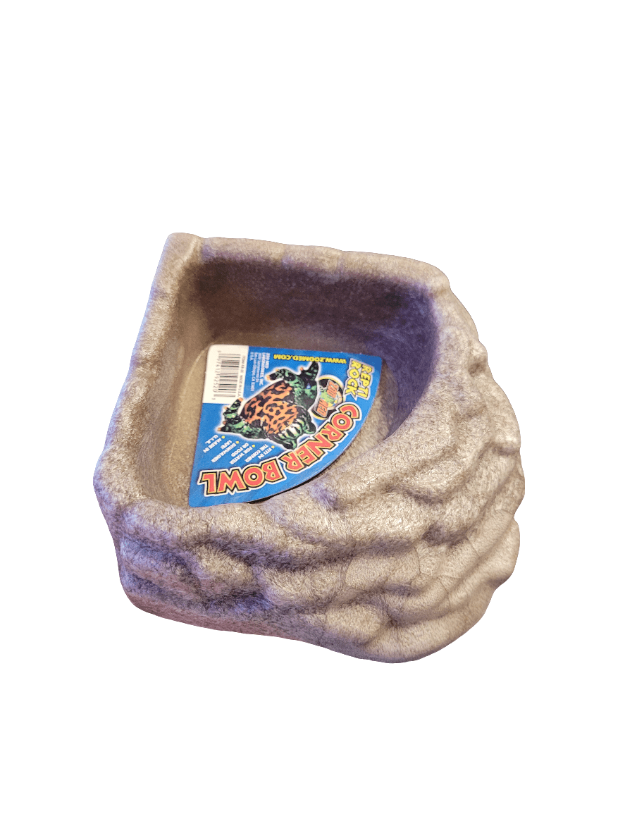 The Zoo Med - Repti Rock Corner Bowl - Small is a corner bowl with a rock-like texture that comes with a label showcasing an image of a gecko. It's crafted for reptile use, featuring a rugged exterior that mimics natural stone.