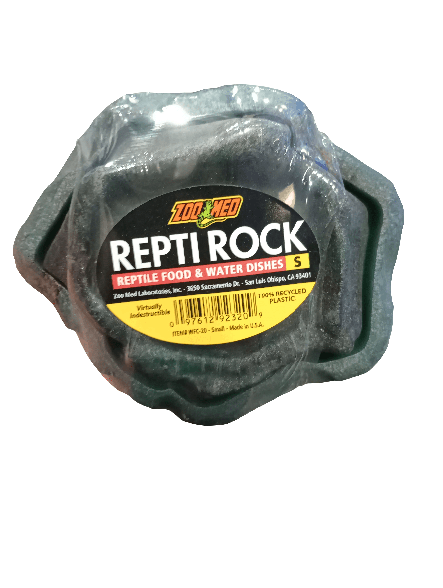 Close-up of a Zoo Med Repti Rock Food And Water Dishes Sml, designed for reptiles. The label notes that it is crafted from 100% recycled plastic and comes in a small size. The packaging also highlights that it is virtually indestructible and made in the USA.