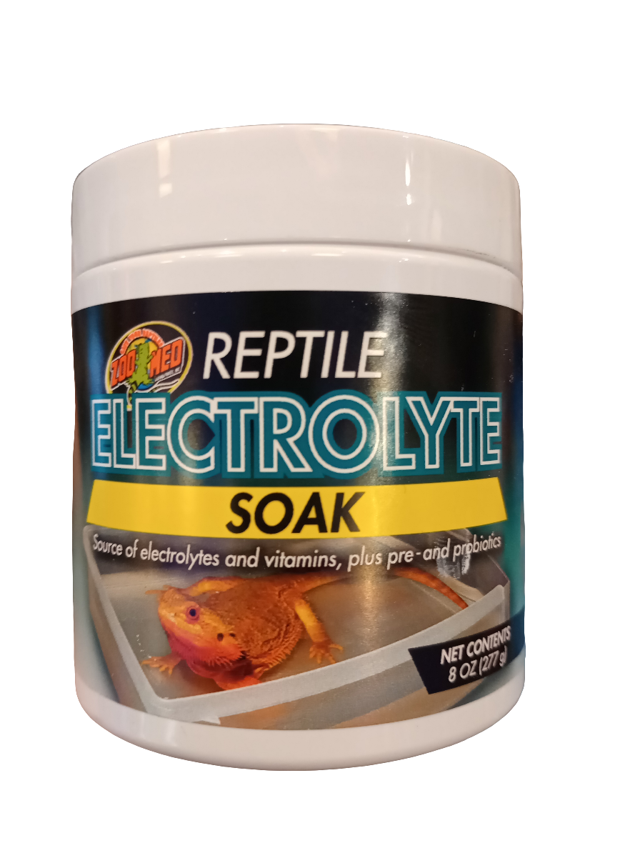 The Zoo Med Reptile Soak Electrolyte 8 Oz container features a label with a lizard in a soaking dish, emphasizing its content of electrolytes, vitamins, prebiotics, and probiotics. Net weight is 227 g.