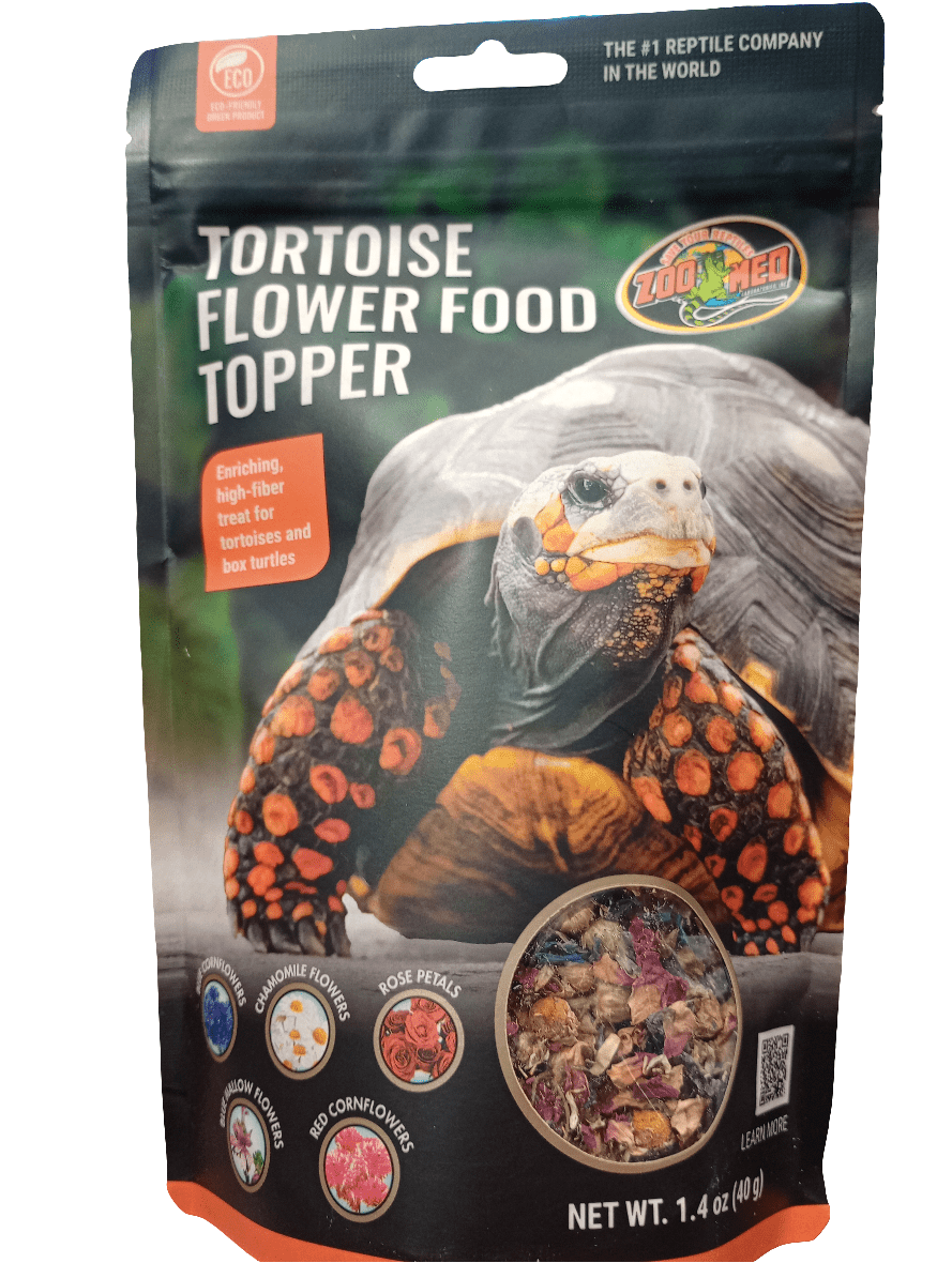 The front of the Zoo Med Tortoise Flower Food Topper package features a photo of a tortoise along with images of ingredients such as dandelion flowers, rose petals, and red cornflowers. The package weighs 1.4 oz (40 g).