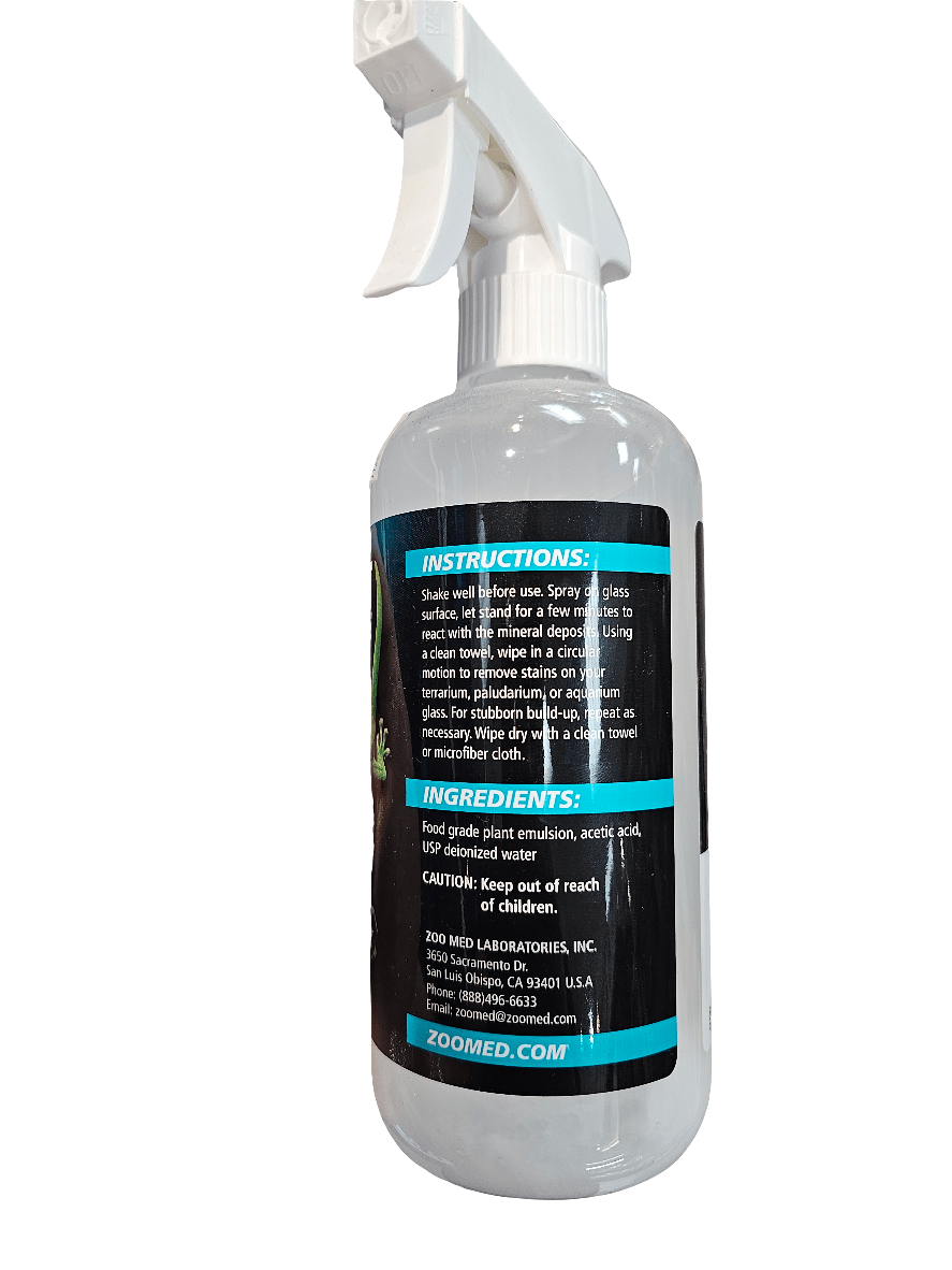 A transparent plastic spray bottle with a white nozzle contains the Zoo Med - Wipeout Glass Cleaner - 16oz. Its label features instructions, plant-based ingredients, and cautionary information. Designed for use as an aquarium glass cleaner, it effectively removes hard water deposits. The brand name Zoo Med Laboratories, Inc., along with contact details, are clearly visible on the bottle.