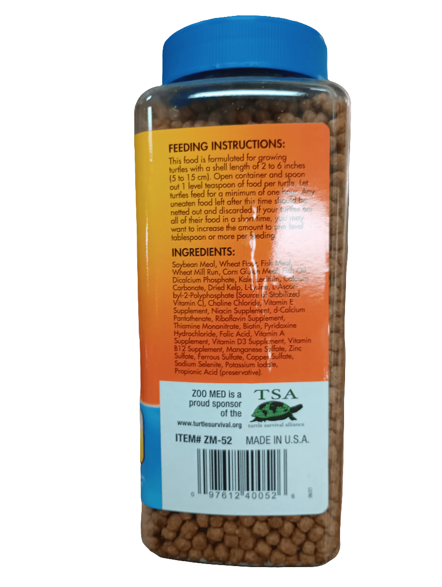 The ZooMed Aquatic Turtle Food 13oz bottle, distinguished by its blue lid, is crafted with natural ingredients such as soybean and fish meals. The label offers feeding instructions tailored for growing turtles and emphasizes the inclusion of essential vitamins and minerals. The TSA and Zoo Med logos are prominently displayed near the bottom, indicating its high quality. Made in the USA.