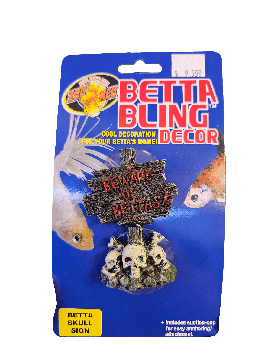 Package image of ZooMed's Betta Bling Decor - Skull Sign, showcasing a sign that reads "Beware of Bettas!" with skull accents. The promotional text highlights it as a cool decoration for your Betta's home. Priced at $9.99, it comes with a convenient suction cup for easy attachment.