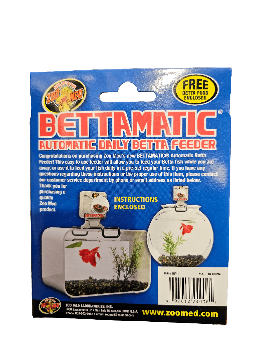 The image displays the packaging for ZooMed's Bettamatic - Automatic Daily Feeder. It includes usage instructions and promotes complimentary Betta food. There is also a small depiction of a fish tank with a betta fish swimming inside.