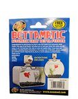 The image displays the packaging for ZooMed's Bettamatic - Automatic Daily Feeder. It includes usage instructions and promotes complimentary Betta food. There is also a small depiction of a fish tank with a betta fish swimming inside.