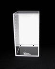 The Vivarium Electronics Acrylic Enclosure - Medium features a clear acrylic display on a black base, with a white back panel. Small holes near its edges offer cross ventilation, making it perfect for showcasing and protecting items in high humidity environments.