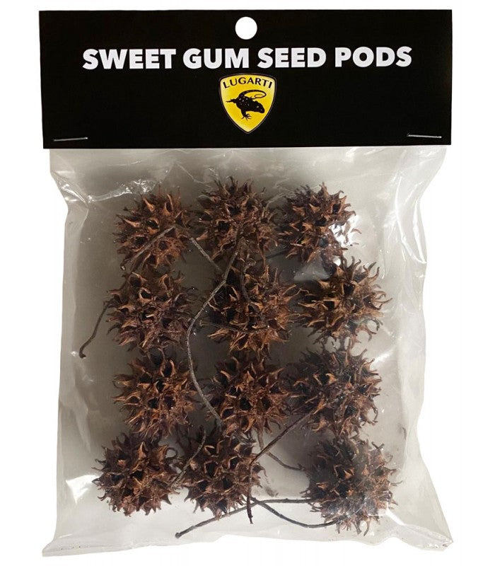 A clear plastic bag labeled Lugarti- Sweet Gum Seed Pods contains multiple pods ideal for terrarium enrichment. It has a yellow emblem with the word Lugarti and a dragon logo, perfect for isopods and small creatures.