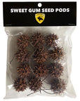 A clear plastic bag labeled Lugarti- Sweet Gum Seed Pods contains multiple pods ideal for terrarium enrichment. It has a yellow emblem with the word Lugarti and a dragon logo, perfect for isopods and small creatures.