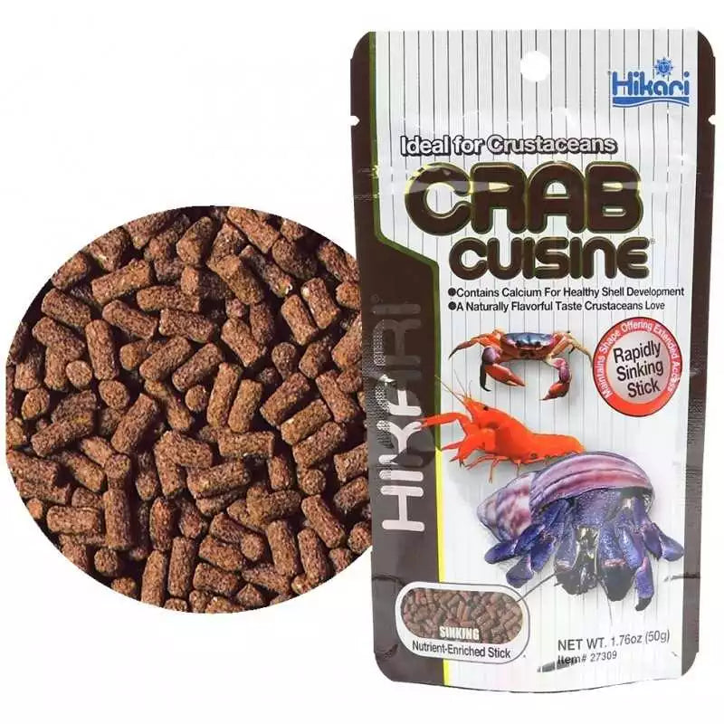 The Hikari Crab Cuisine package (1.76oz) shows brown, sinking sticks and images of a crab and hermit crab. It highlights its benefits for crustaceans, focusing on calcium content to support shell development.