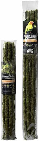 Two transparent packages of Galapagos Mossy Sticks feature a yellow bird and product details. The sticks resemble treats or perches; one package is taller, and the other shorter, making them ideal for diverse pet families, including chameleons and geckos.